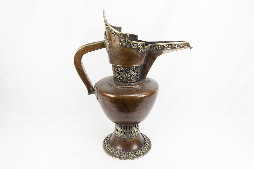 Lot 261: A Tibetan Large Copper Monk's Cap Ewer Decorated...