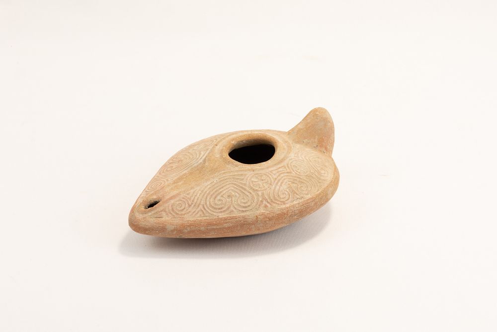 Lot 275: A Terracotta Oil Lamp Designed with Floral Patterns...