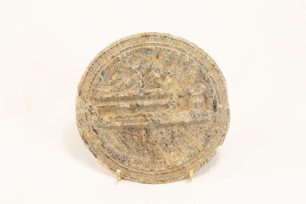 Lot 295: A Gandharan Schist Palette Depicting a Banquet Scene...