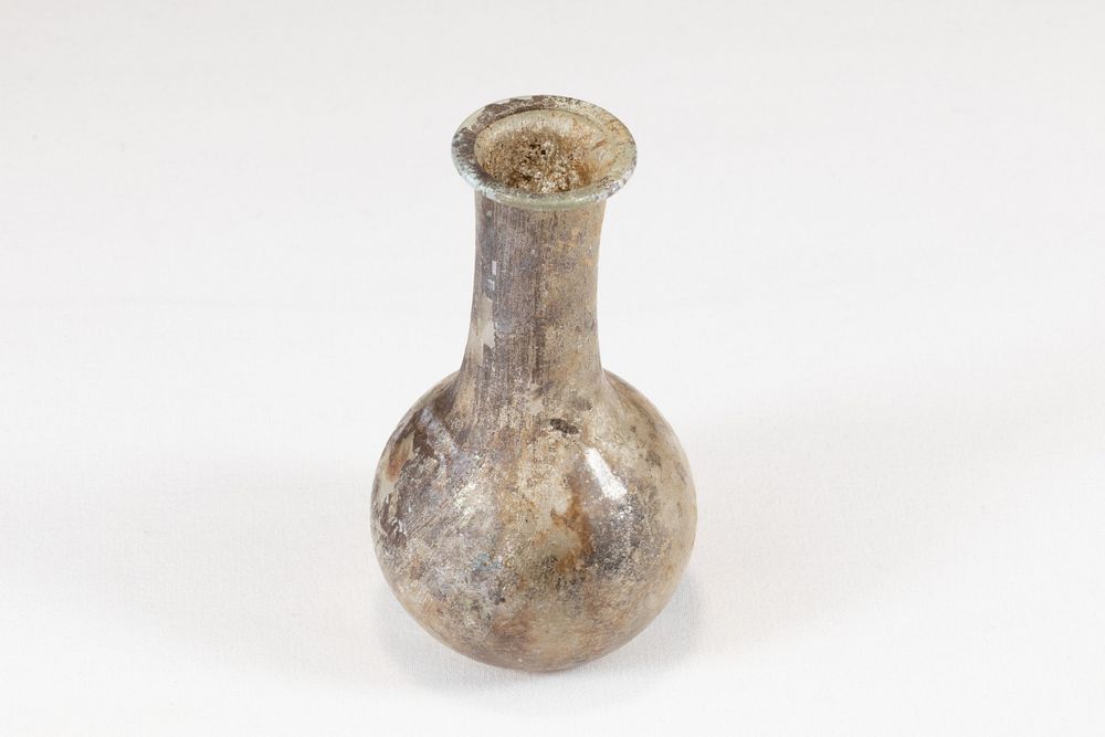 Lot 319: An Ancient Roman Glass Unguentarium Blown from Translucent...