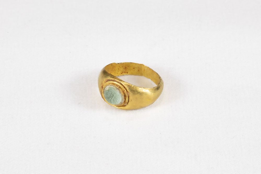 Lot 321: An Ancient Roman Gold Ring with Glass Cabochon...