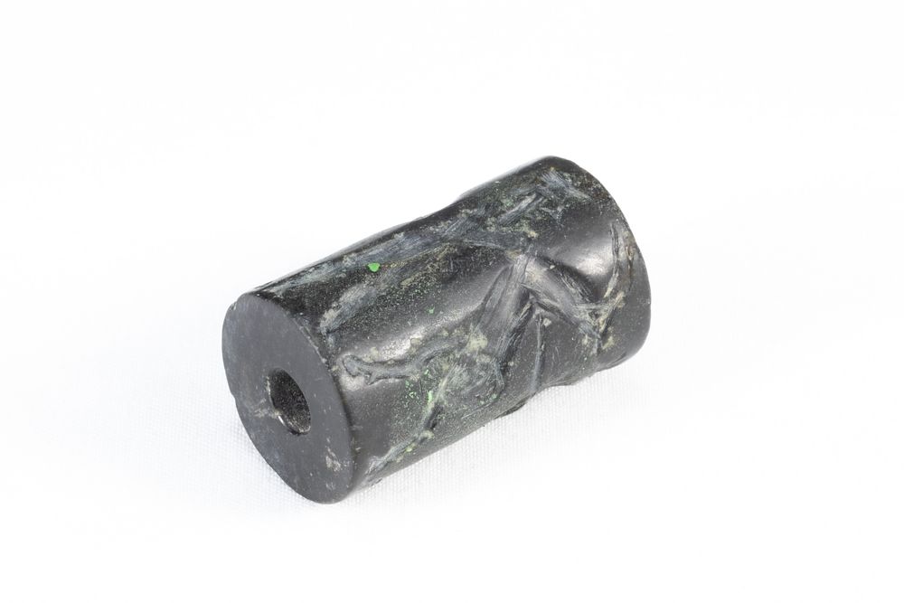 Lot 329: A Mesopotamian Black Hardstone Cylinder Seal with Zoomorphic...