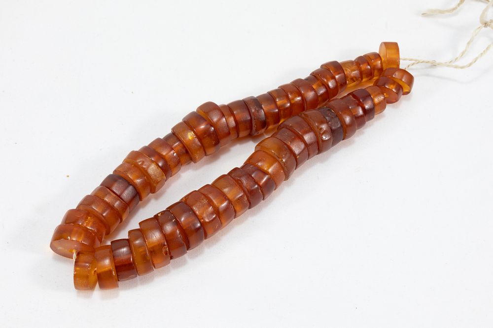 Lot 56: A Single Strand Tibetan Amber Beads Necklace.