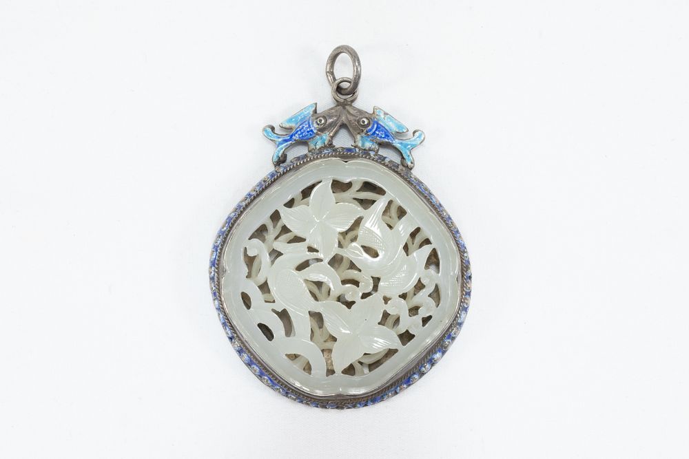 Lot 108: A Chinese Carved Silver White Jade Pendant Decorated...