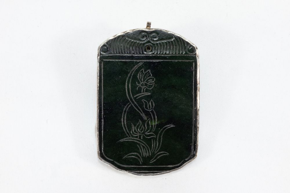 Lot 109: A Chinese Dark Green Jade & Silver Pendant...