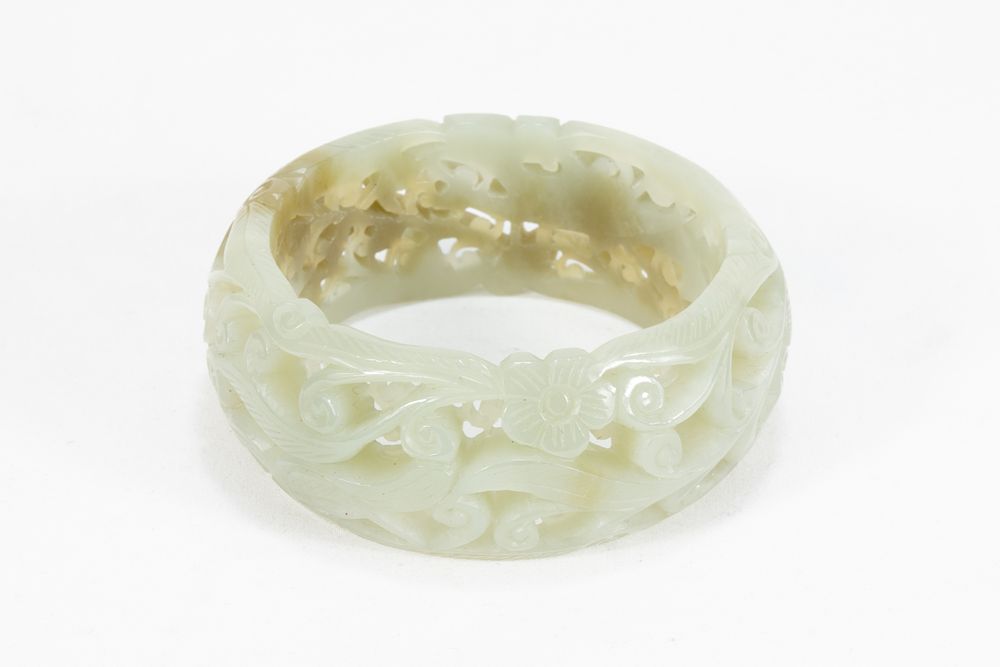Lot 114: A Chinese Hetian Hand Carved Jade Bangle.