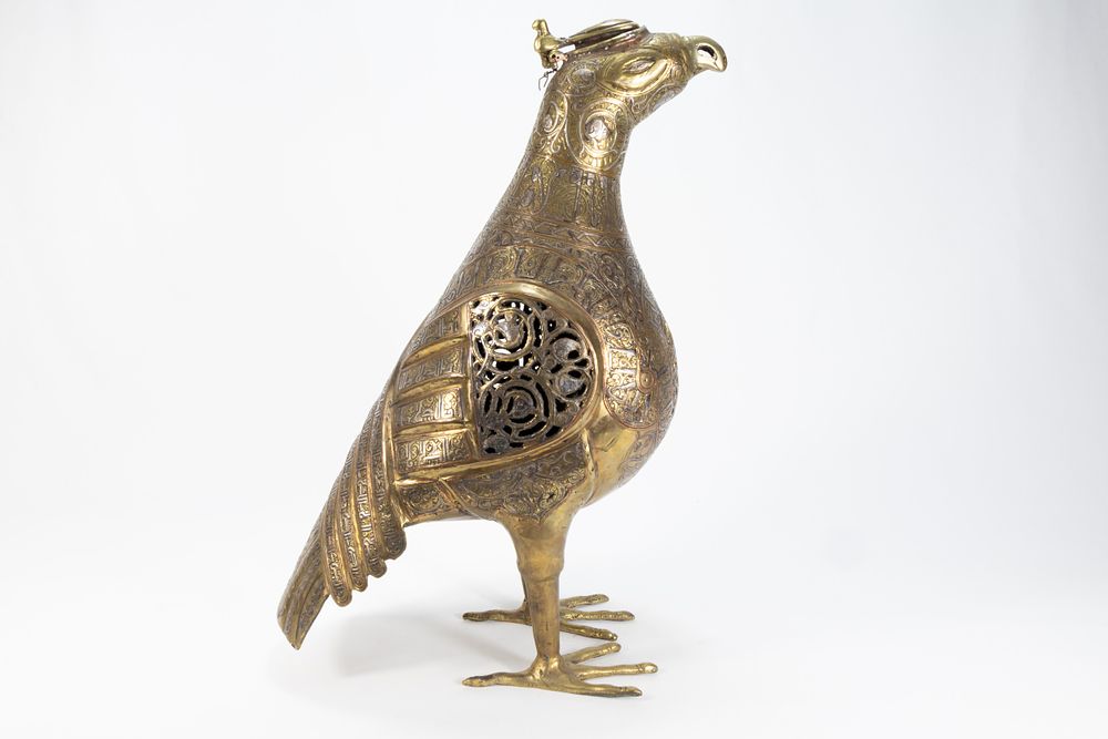 Lot 165: An Islamic Bronze Figure of a Bird Decorated...