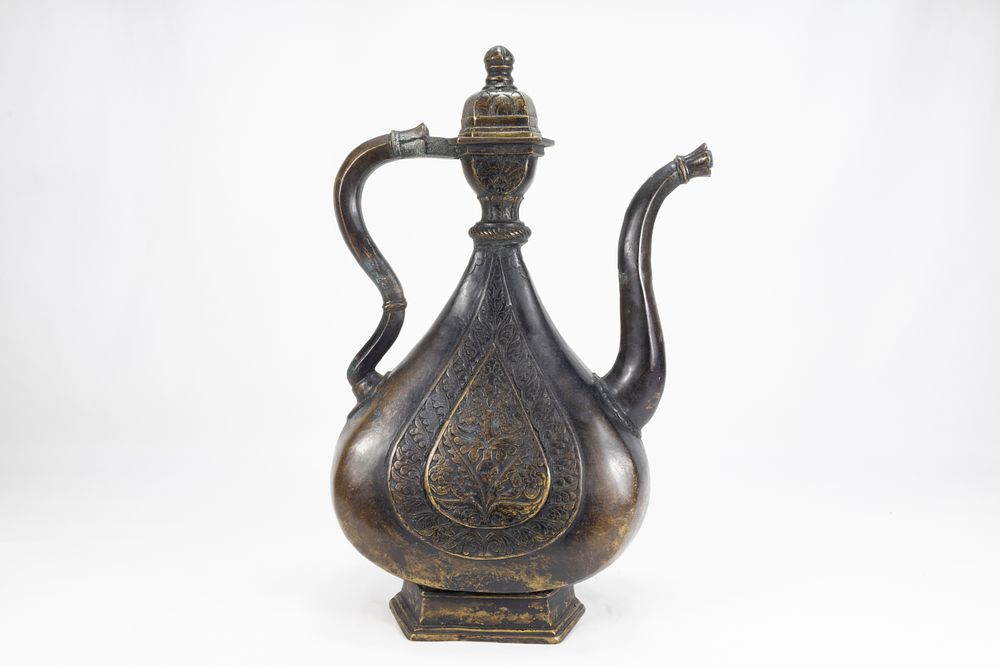 Lot 202: An Islamic Indian Mughal Bronze Ewer Decorated with...