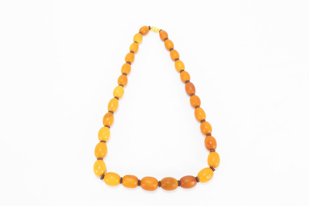 Lot 329: A Single Strand Graduated Butterscotch Amber & Leather...