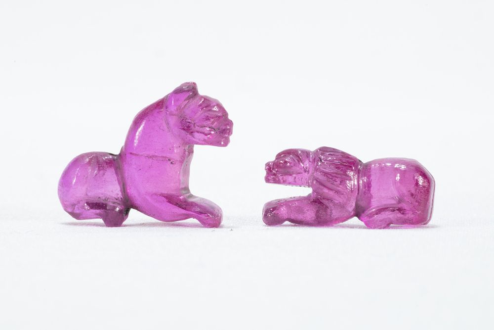 Lot 334: A Lot of 2 Carved Pink Gemstone Figures...