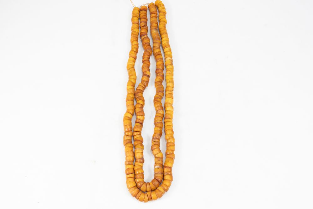 Lot 346: A Pair of Tribal Moroccan Amber Coloured Beads...
