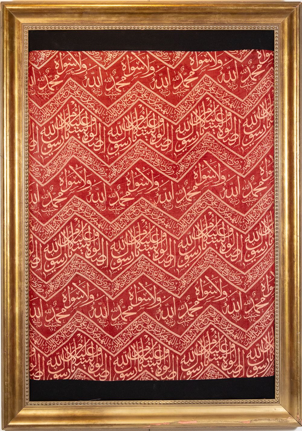 Lot 114: An Islamic Ottoman Red Silk Framed Kiswa Decorated...