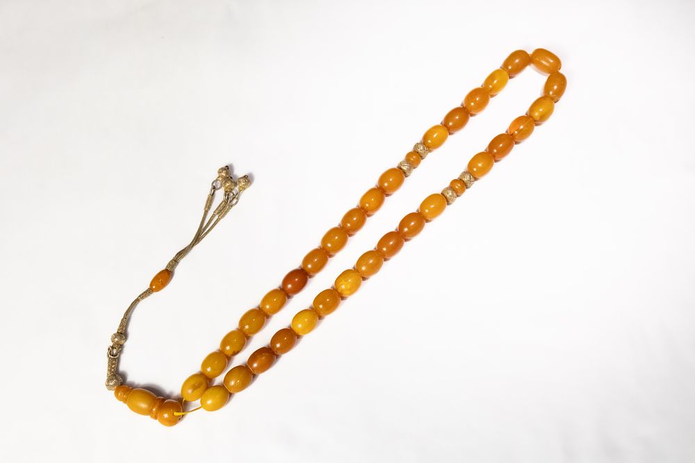 Lot 123: An Islamic Butterscotch Amber Tasbih Prayer Beads with...