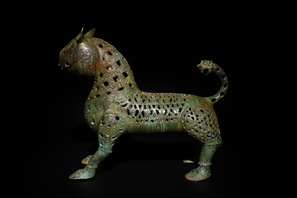 Lot 139: An Islamic Bronze Lion Decorated with Intricate Openwork.
