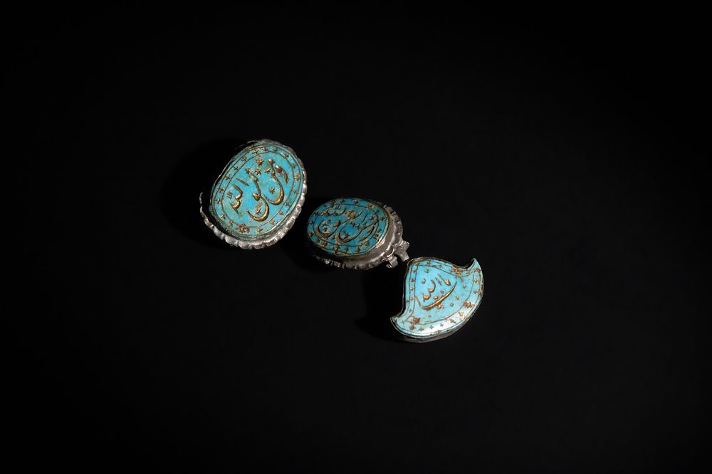 Lot 141: An Islamic Qajar Turquoise Brooch Inscribed with Islamic...