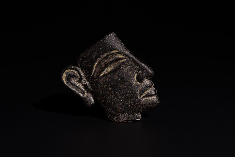 Lot 171: An Egyptian Granite Face of a Young Pharaoh,...