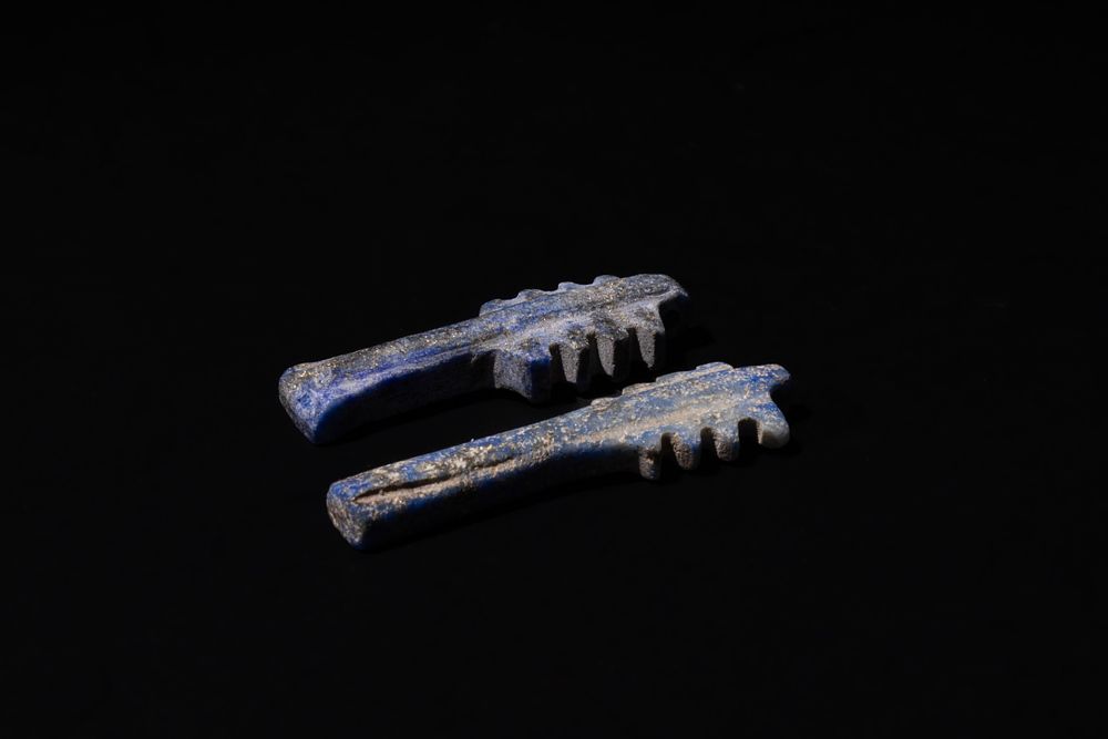 Lot 198: An Egyptian Pair of Lapis Lazuli Cestrum Pendants,...