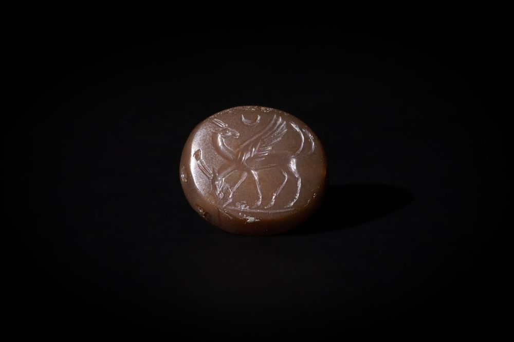 Lot 219: A Greco-Persian Dark Red Agate Scarab Depicting Two...