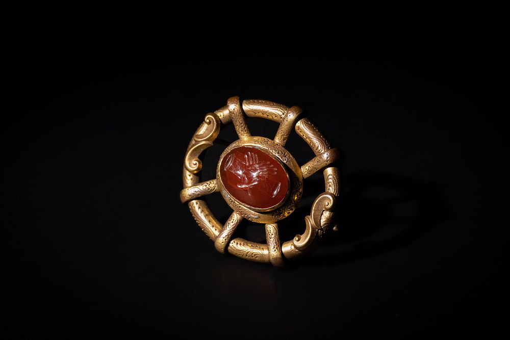Lot 221: A European Medieval Brooch with a Carnelian Engraved...