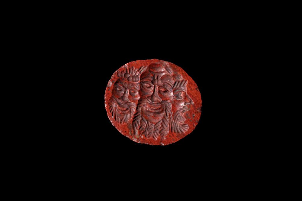 Lot 227: A Roman Bloodstone Intaglio of 3 Masks Theatre,...
