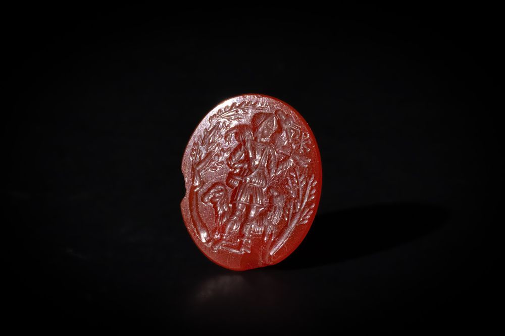 Lot 228: A Roman Carnelian Intaglio of a Shepherd Carrying...