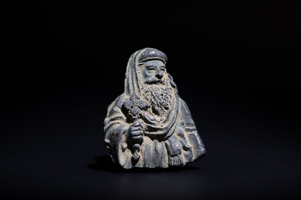 Lot 234: A Bronze Plaque of a Holy Man Holding...