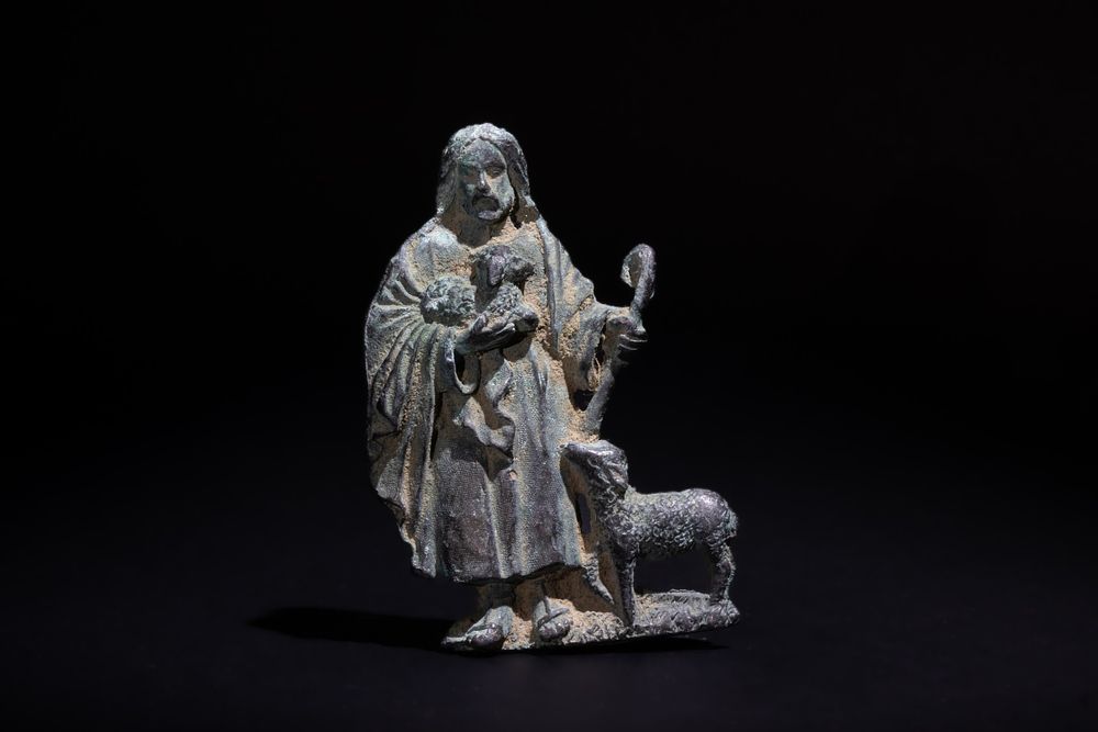 Lot 235: A Bronze Plaque of a Standing Figure Holding...