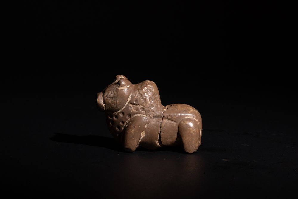 Lot 253: A Near Eastern Stone Figure of a Cow...