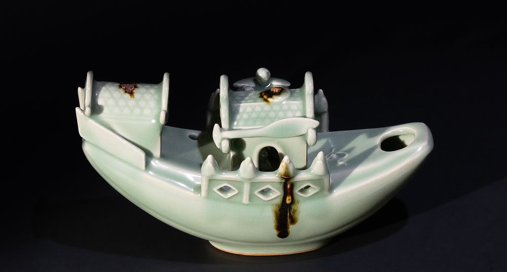 Lot 169: A Chinese Glazed Celadon Figure of a Boat...