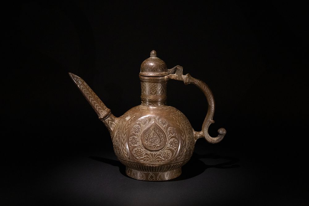 Lot 220: An Indian Mughal Engraved Brass Ewer, 18-19th Century,...