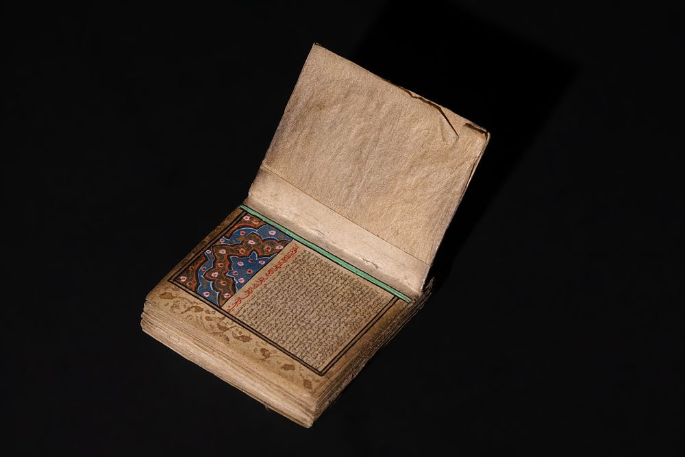 Lot 258: An Islamic Vintage Miniature Qur'an Decorated with Enamel...