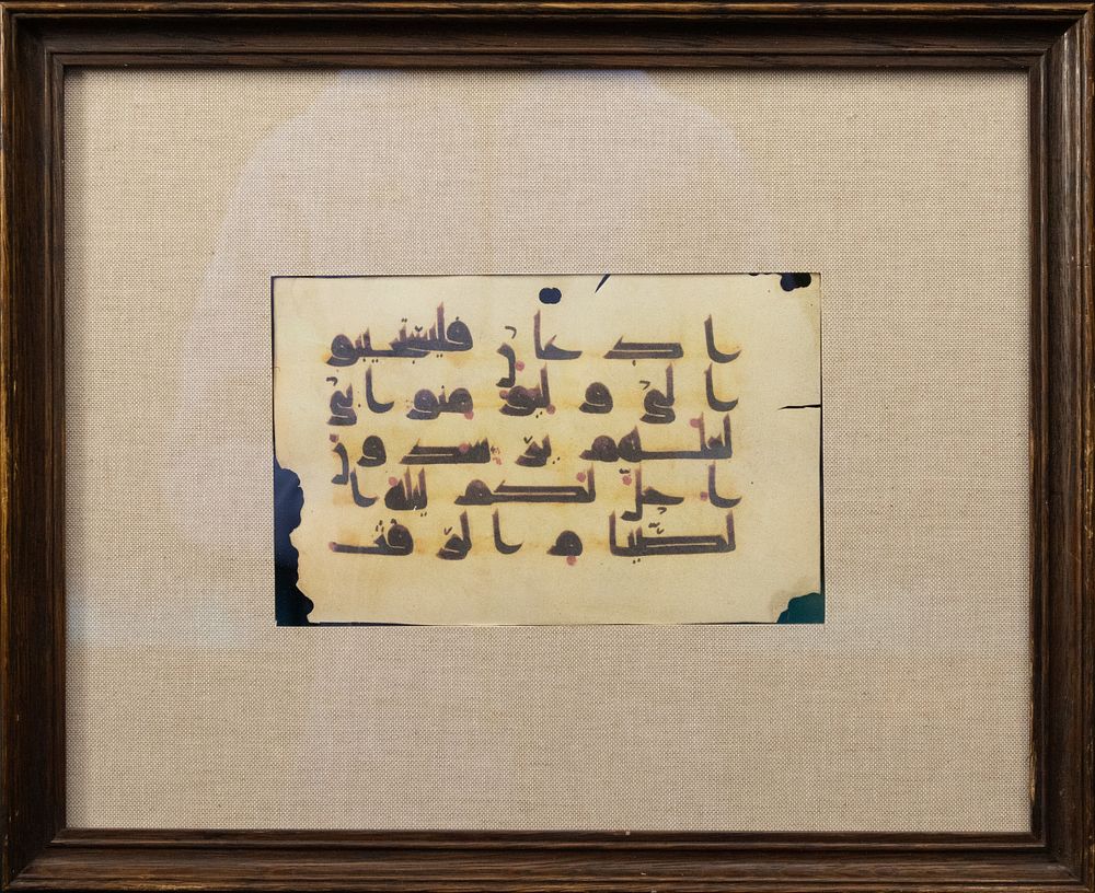 Lot 318: An Islamic Two-sided Kufic Framed Manuscript Fragment.