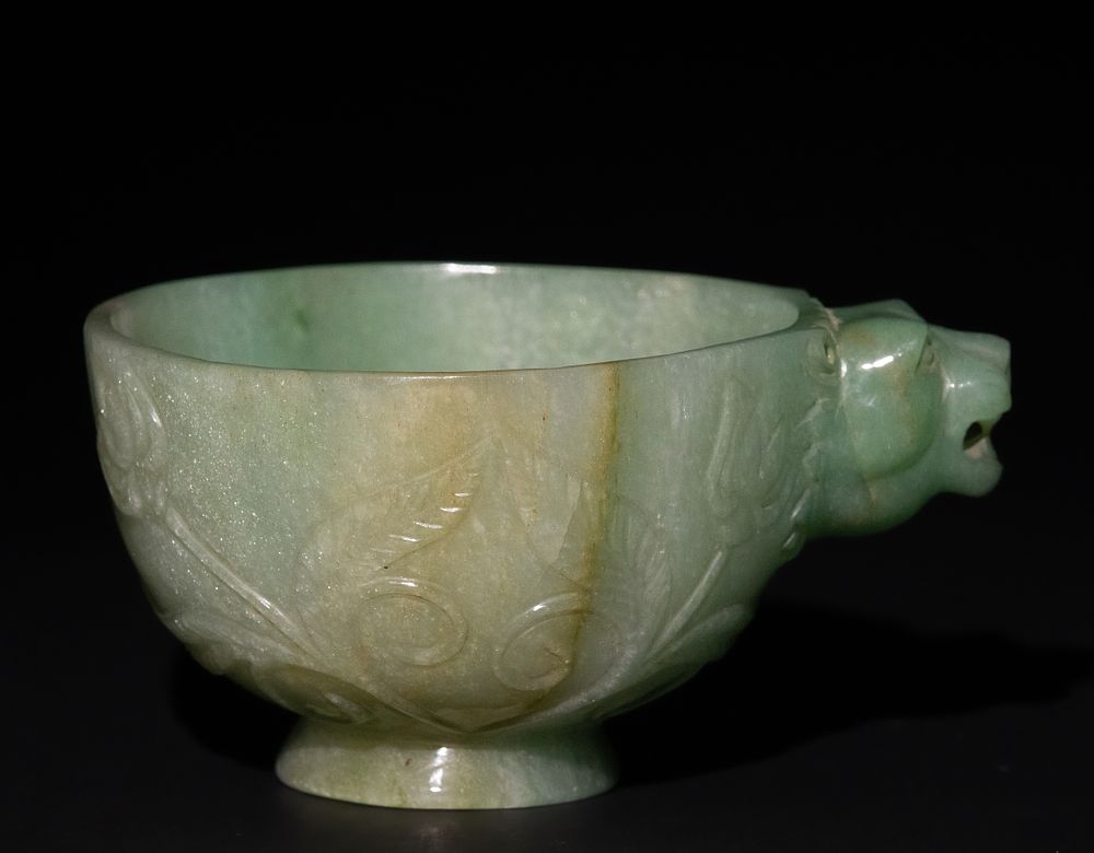 Lot 158: A Mughal-Style Green Jade Bowl with Lion-Head Handle.