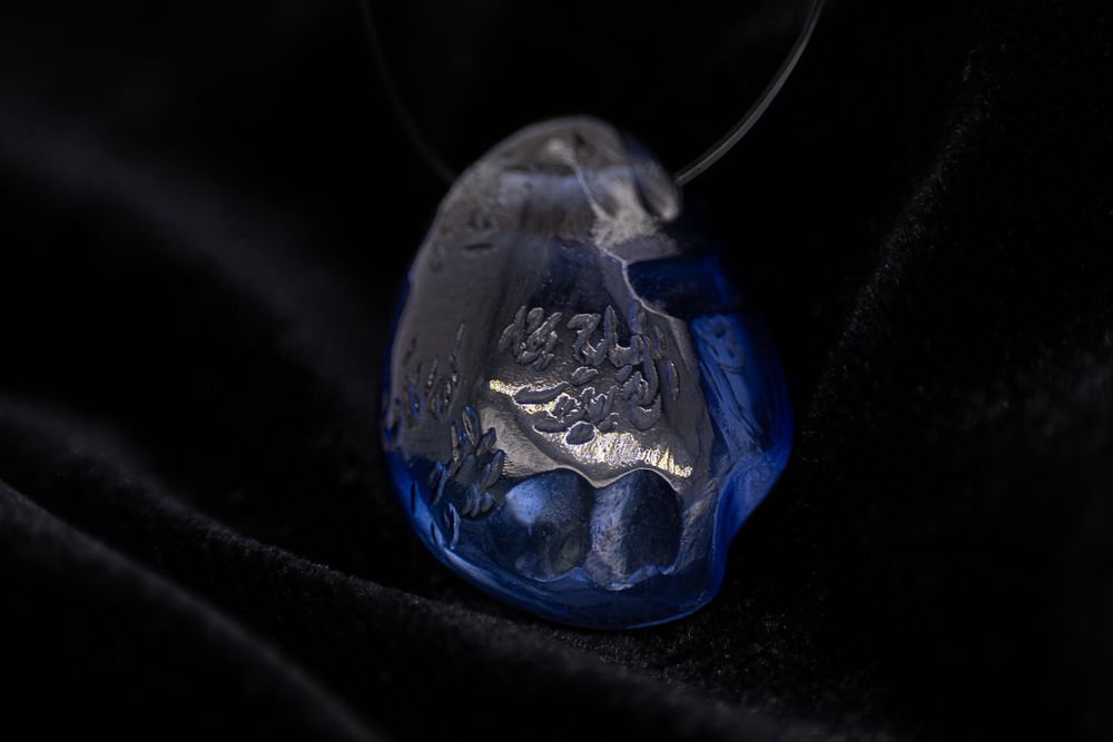 Lot 186: A Faceted Indian Blue Gemstone Pendant, Inscribed with...