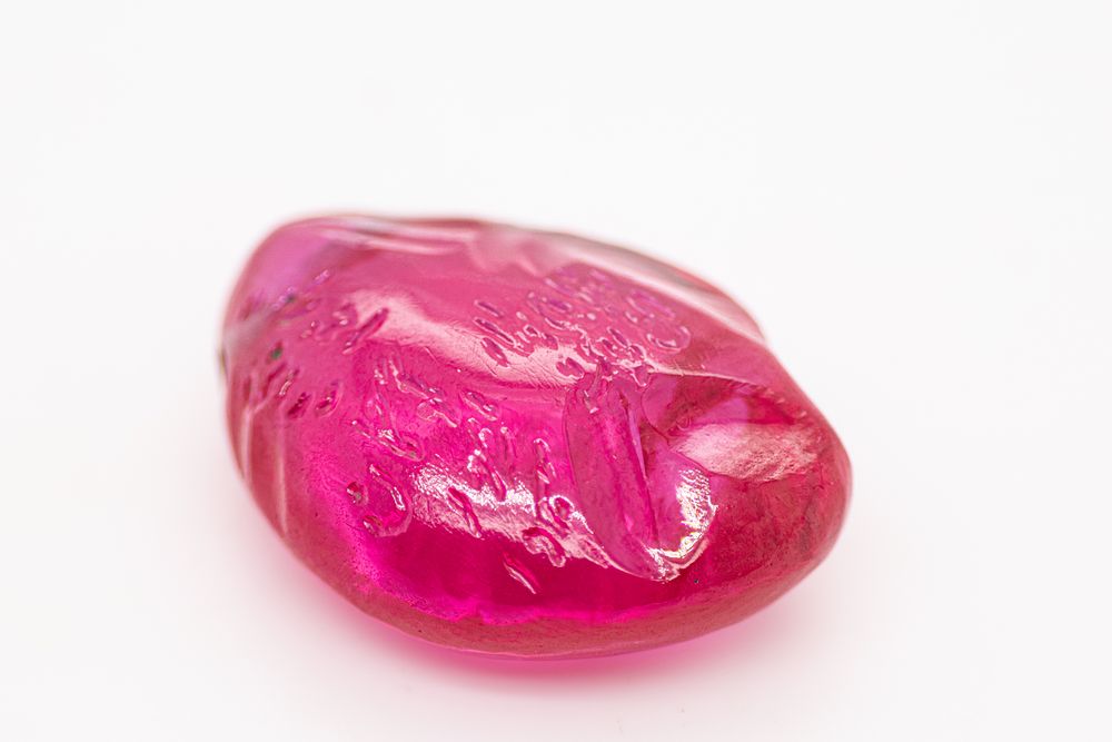 Lot 187: An Indian Carved Pink Gemstone Pendant, Inscribed with...