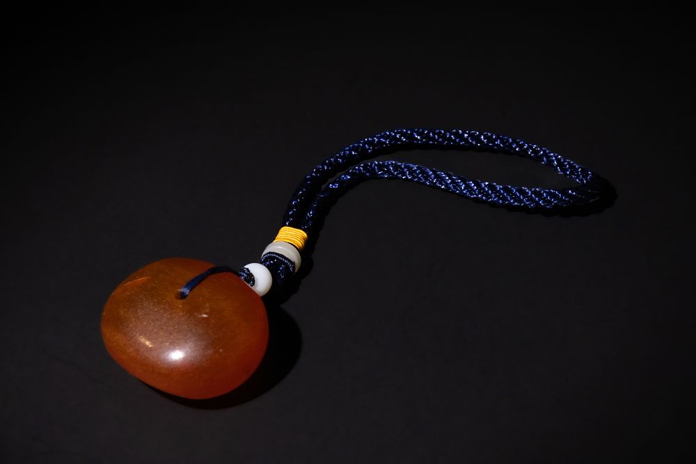 Lot 192: A Tribal Yemeni Pressed Amber Pendant with Braided...