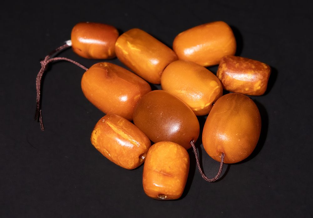 Lot 197: An Assorted Collection of Amber Beads in Various...