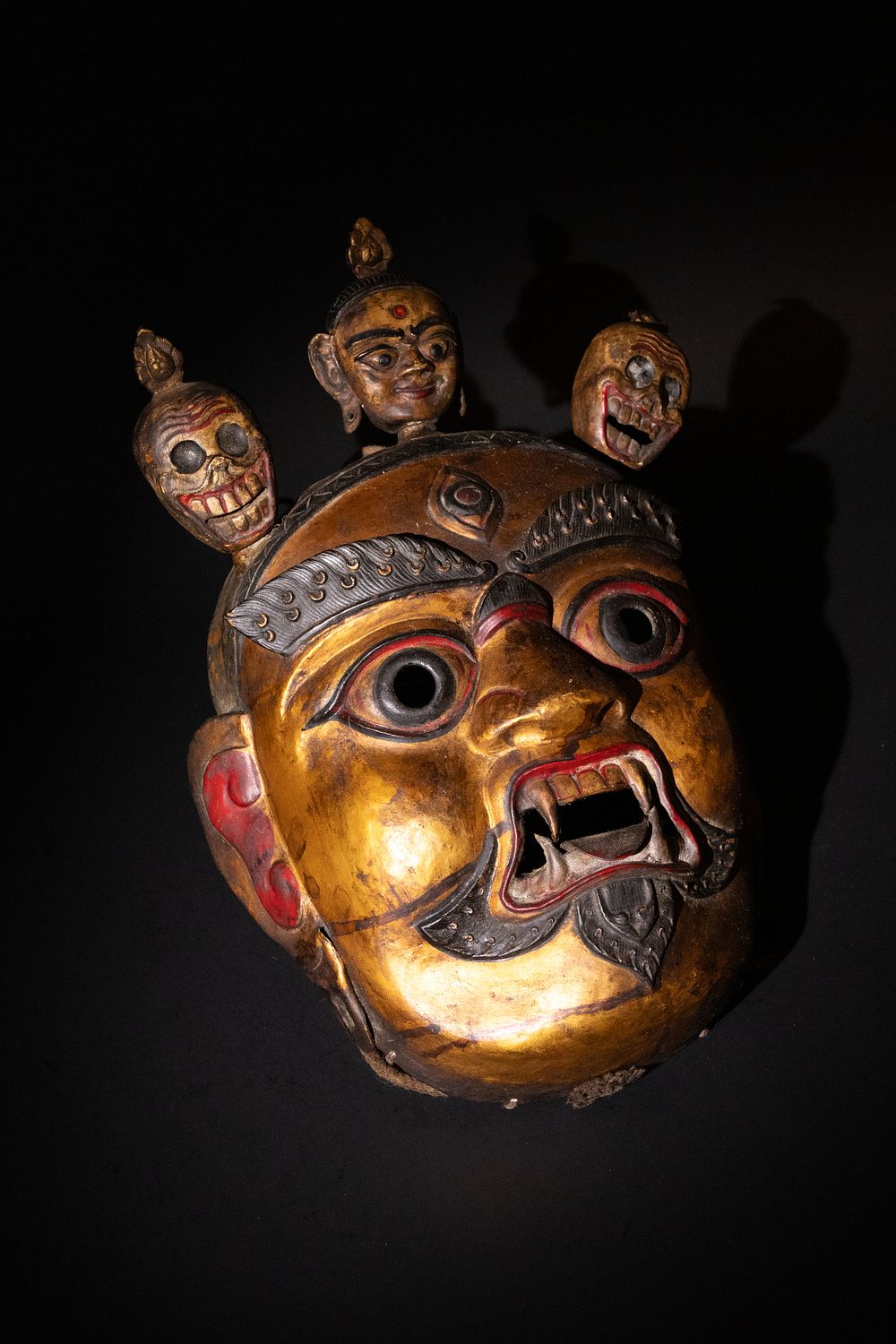Lot 204: A Tribal Tibetan Bronze Buddhist Wall Hanging Mask.
