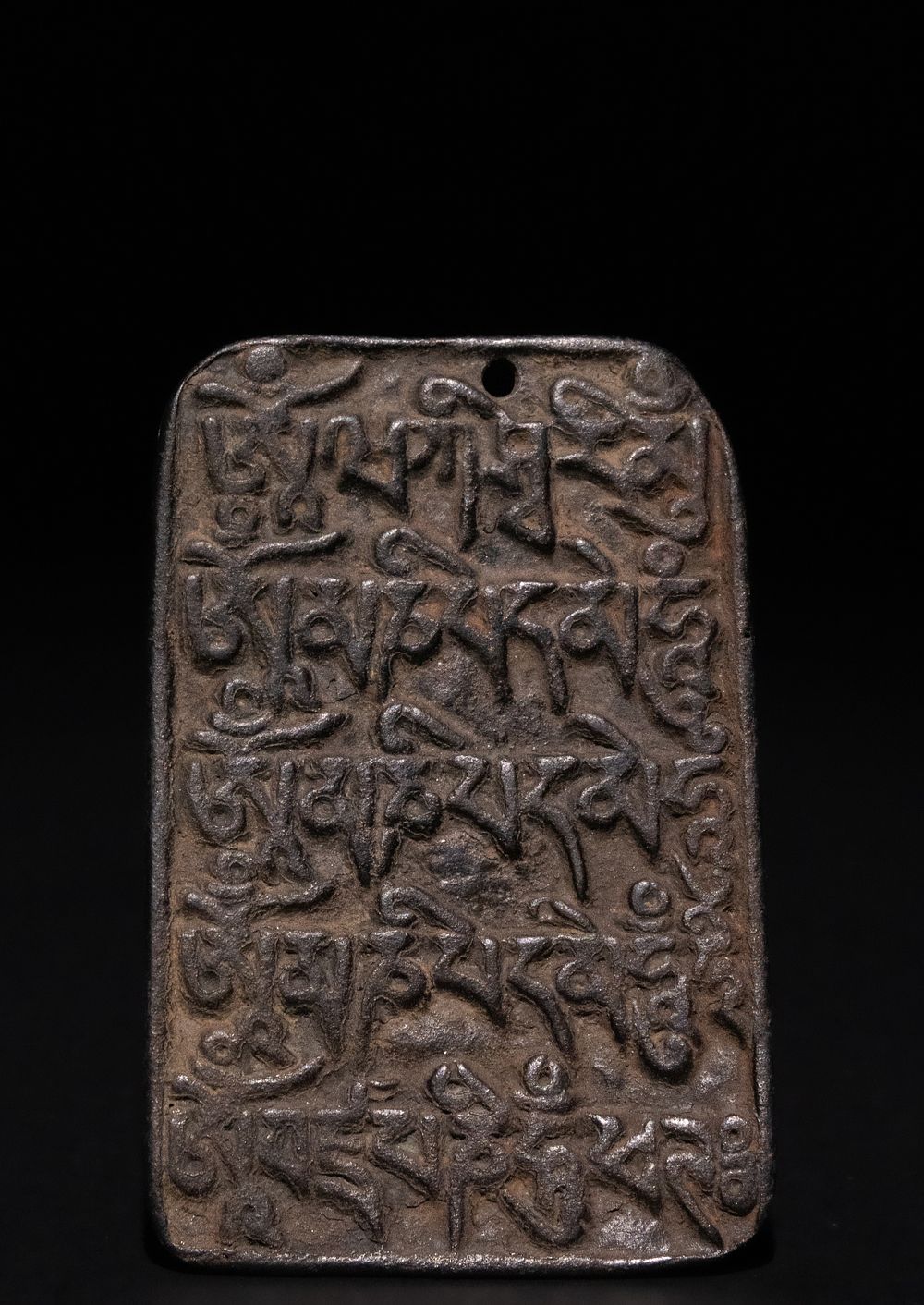 Lot 214: A Tibetan Bronze Plaque with Engraved Mantras.