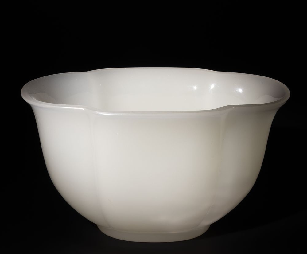 Lot 251: A Chinese White-Glazed Carved Mallow Shaped Bowl.