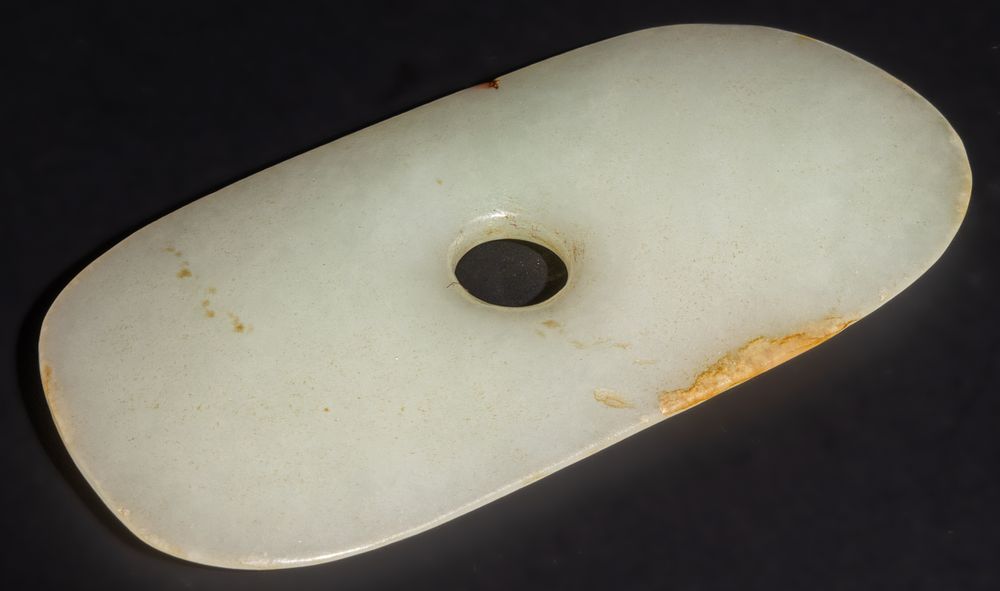 Lot 259: A Chinese Jade Bi Disk with a Central...