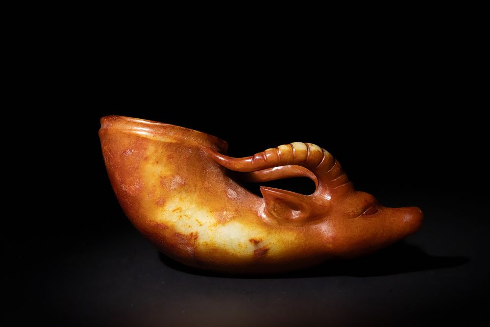 Lot 274: A Chinese Carved Jade Rhyton Cup with Ram's...