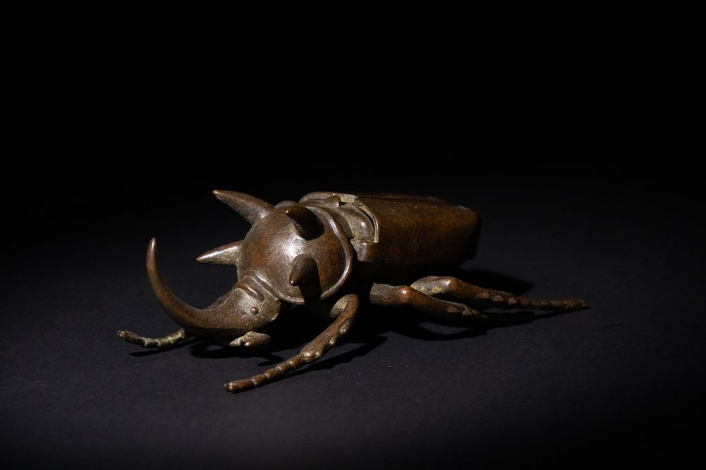 Lot 183: A Japanese Bronze Rhinoceros Beetle Figurine.