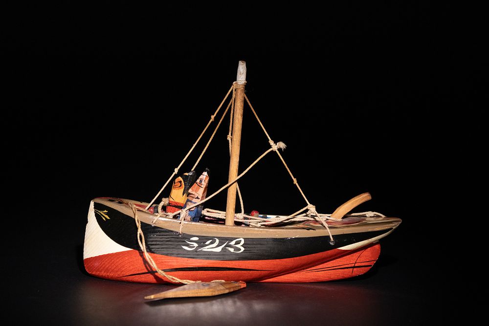 Lot 283: A Sam Smith ‘Wise Gal’ Hand-Carved Wooden Boat.