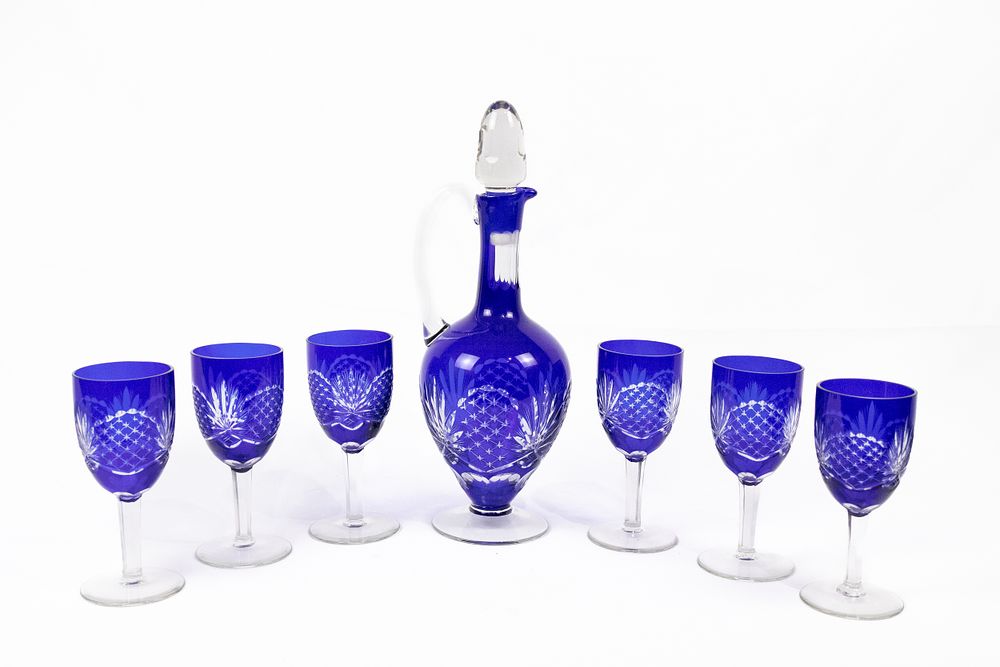 Lot 284: A Bohemian Cobalt-Cut Decanter and Goblet Set.