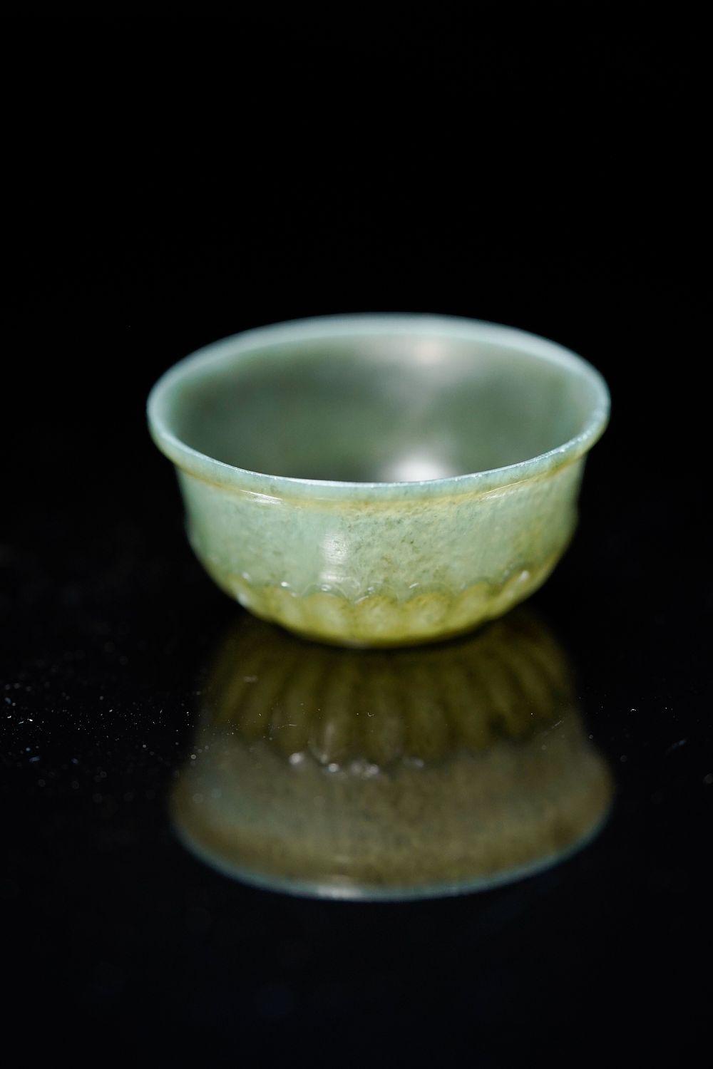 Lot 179: A Mughal Carved Jade Bowl with Petal Motif.