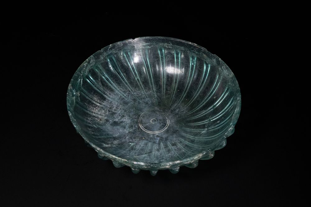 Lot 246: A Roman Ribbed Green Glass Bowl.
