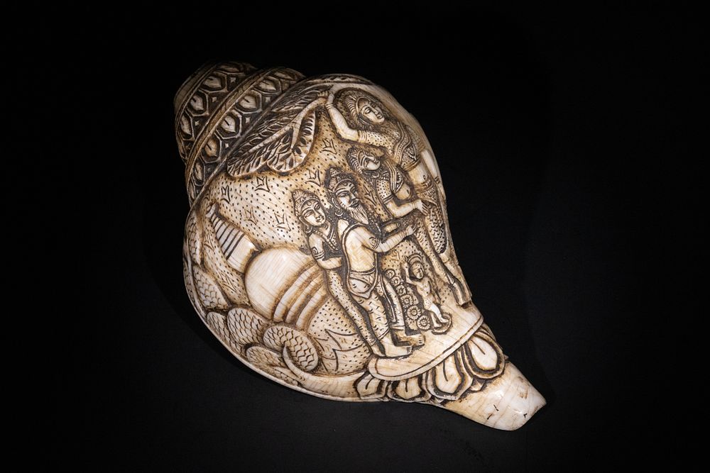 Lot 262: A Tibetan Carved Conch Shell with Incised Figures...