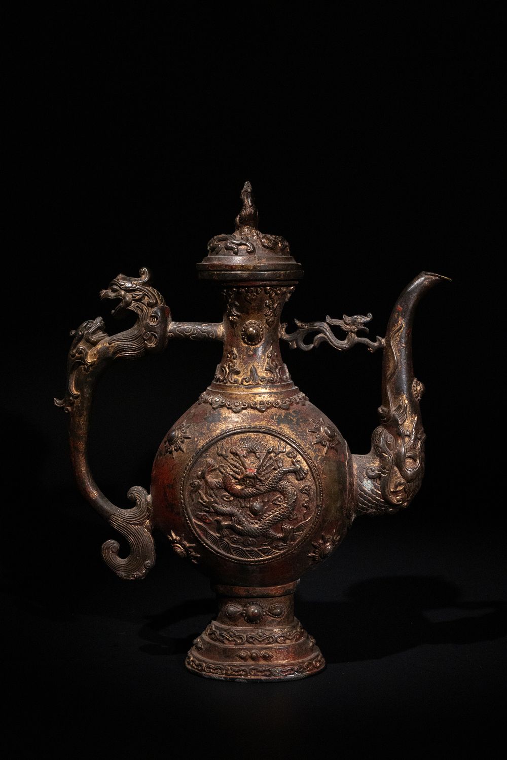Lot 264: A Tibetan Gilt Bronze Ewer with Dragon Motifs...