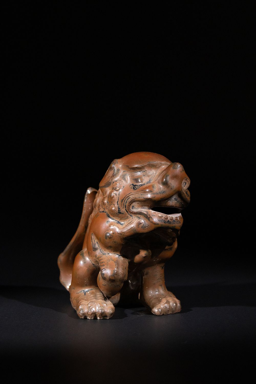 Lot 280: A Chinese Ceramic Foo Lion with Incised Motifs.